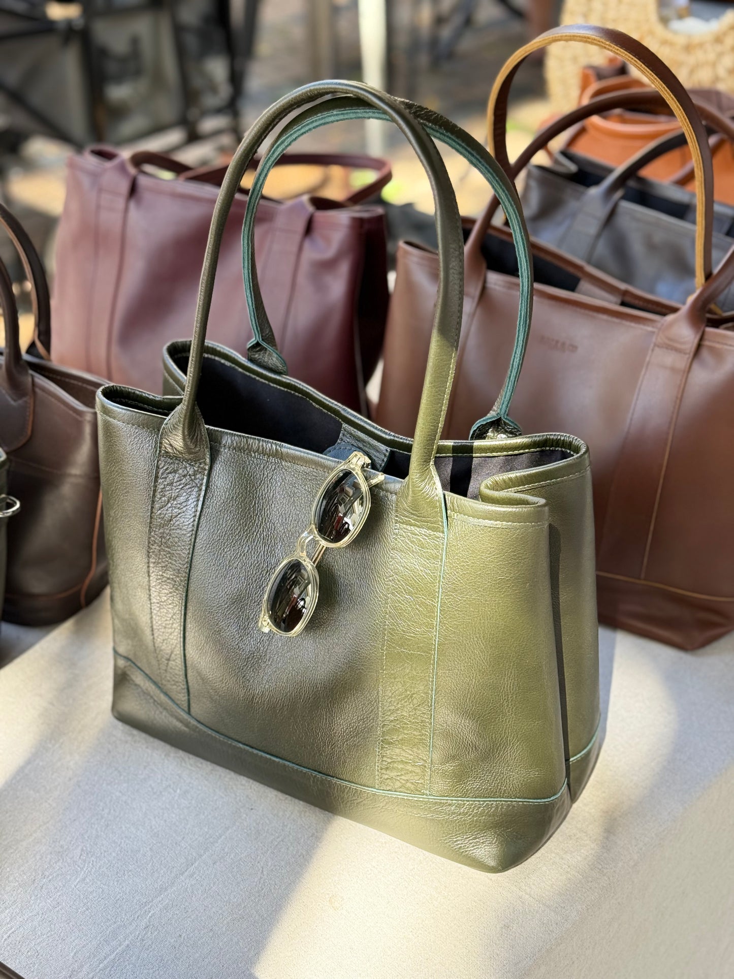 Handmade leather tote bag with high-quality genuine leather, interior zippered pockets, and adjustable shoulder straps. Spacious enough for a 13-inch laptop, perfect for work or daily use.